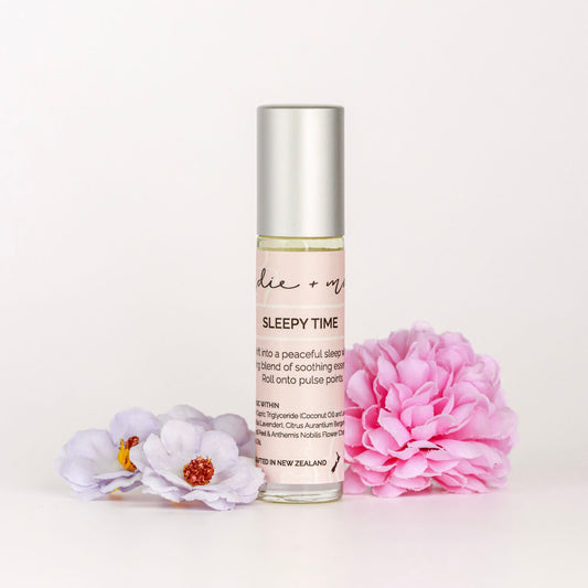 Indie + Mae | Aromatherapy Roller | Roll-on bottle labeled 'Sleepy Time' with flowers on a light background