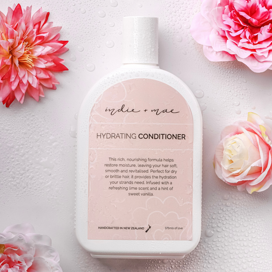 Hydrating conditioner bottle with pink flowers on a light background | Indie + Mae