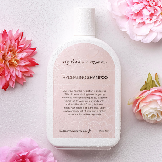 Hydrating shampoo bottle with pink flowers on a light background | Indie + Mae