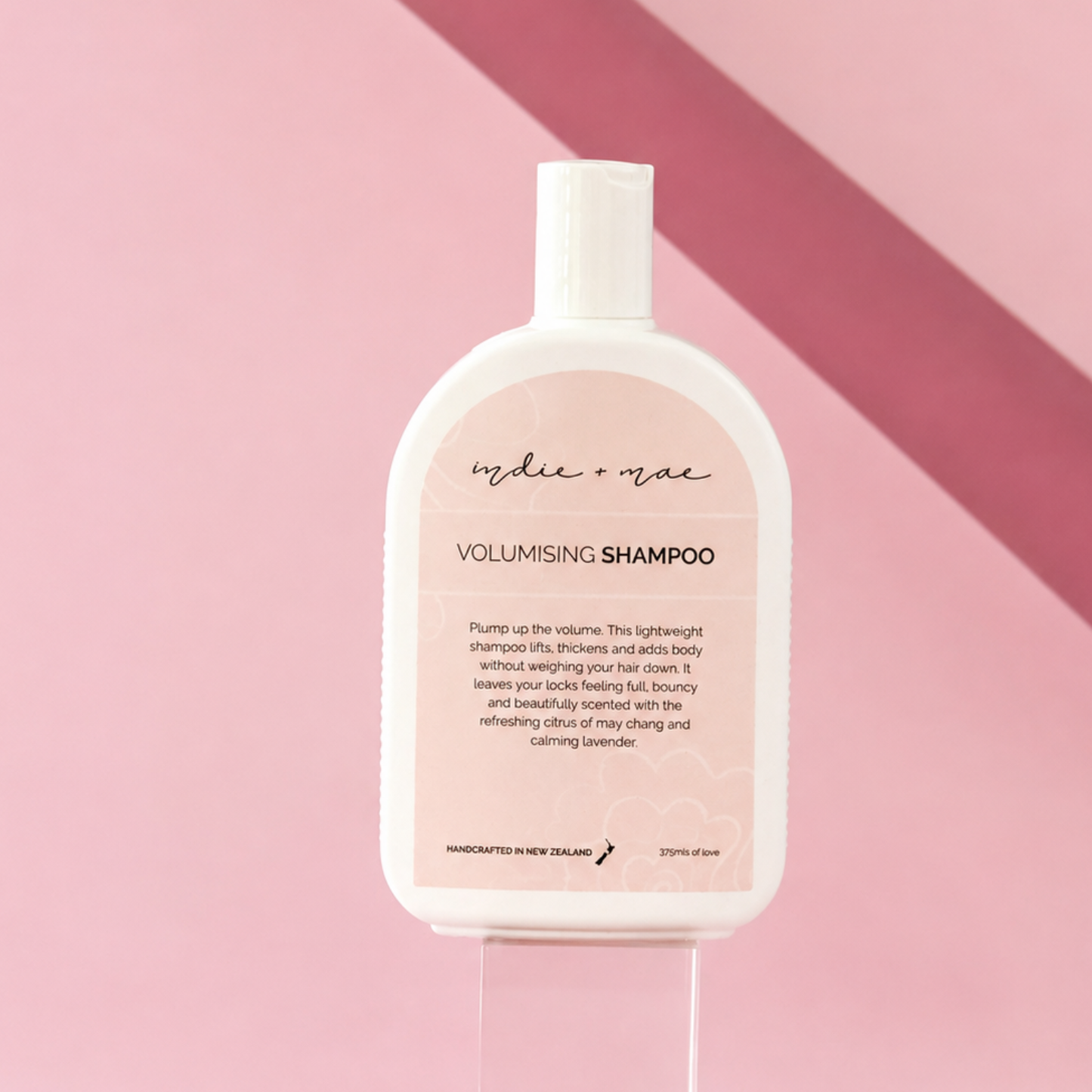 Indie + Mae Volumising Shampoo bottle, styled product photo