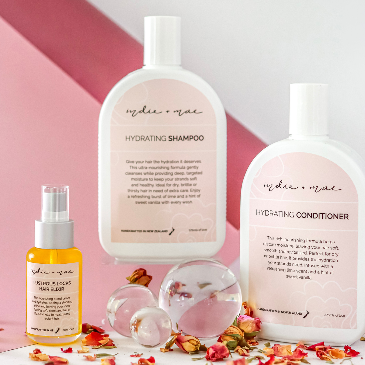 Indie + Mae Hydrating Trio with shampoo, conditioner and Lustrous Locks Hair Elixir, styled product photo